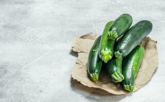 Fresh zucchini on paper. photo