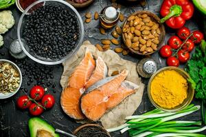 Healthy food. Salmon steaks with organic vegetable and nuts. photo