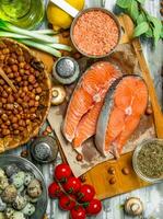 Healthy food. Salmon with organic vegetables, fruits and nuts. photo