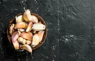 Pieces of garlic in the bowl. photo