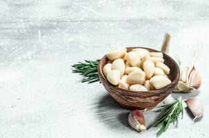 Cloves of garlic in a bowl. photo