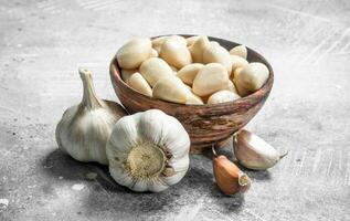 Cloves of garlic in a bowl. photo