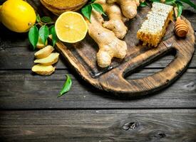 Ginger with lemon and honey on the cutting Board. photo