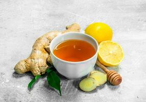 Ginger tea in cup and lemon. photo