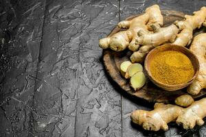 Ground and fresh sliced ginger on a cutting Board. photo