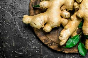 The sweet of fresh ginger on a wooden cutting Board. photo