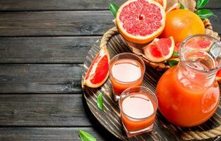 Grapefruit juice in a glass on tray. photo