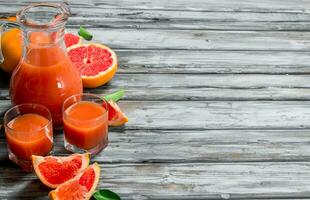 Grapefruit juice in a glass pitcher. photo