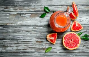 Grapefruit juice in a glass pitcher. photo