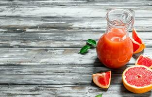 Grapefruit juice in a glass pitcher. photo
