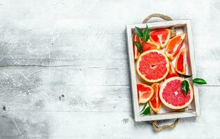 Pieces of ripe grapefruit on a tray. photo