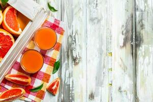 Grapefruit juice in a glass on a napkin. photo