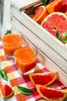 Grapefruit juice in a glass on a napkin. photo