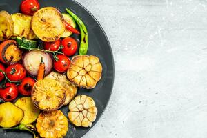 Grilled vegetables on a plate with spices. photo