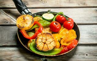 Different grilled vegetables with herbs and spices. photo