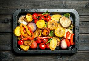 Different grilled vegetables with herbs and spices. photo