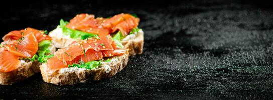 A flavorful salmon sandwich on the table. photo