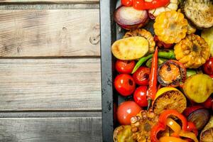 Different grilled vegetables with herbs and spices. photo