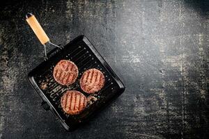 Grilled burger in a frying pan. photo