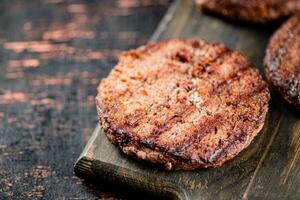 Burger grill on a wooden cutting board. photo