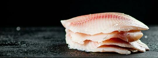 Uncooked fish fillet on the table. photo