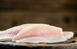 Fresh fish fillet on a cutting board. photo