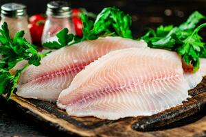 Fresh fish fillet on a cutting board. photo