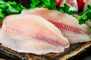 Fresh fish fillet on a cutting board. photo