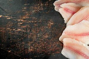 Fresh raw fish fillet on the table. photo