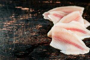 Fresh raw fish fillet on the table. photo