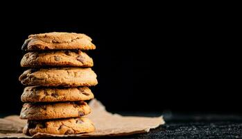 A pile of milk chocolate cookies. photo