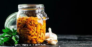 Fragrant pickled mushrooms in a glass jar. photo