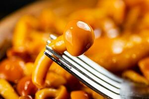 One marinated mushroom on a fork. photo