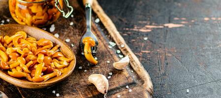 Marinated mushrooms on a cutting board. photo