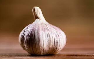 A whole head of fresh garlic on the table. photo