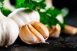 Fragrant garlic with parsley on the table. photo