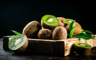 Fragrant kiwi with leaves on tray. photo