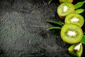 Pieces of kiwifruit with leaves. photo