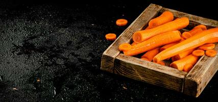 Fresh carrots on a wooden tray. photo