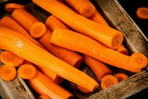 Fresh carrots on a wooden tray. photo