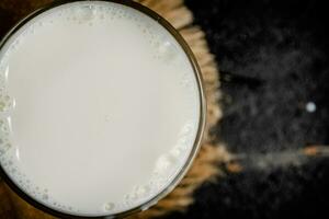 A full glass of fresh milk on a napkin. photo