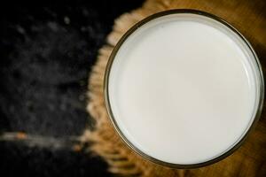 A full glass of fresh milk on a napkin. photo