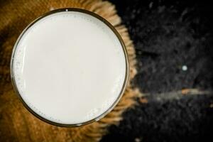 A full glass of fresh milk on a napkin. photo