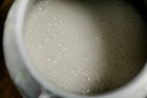 Village milk in a can. Macro background. photo