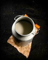 Fresh milk in a can on the table. photo