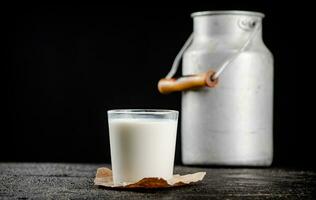 Fresh country milk in a glass on the table. photo