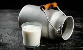 Fresh country milk in a glass on the table. photo