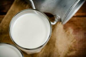 A glass of homemade village milk. photo