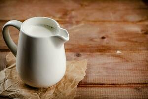 A jug of fresh milk on the table. photo