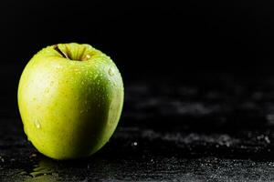 One fresh green apple on the table. photo